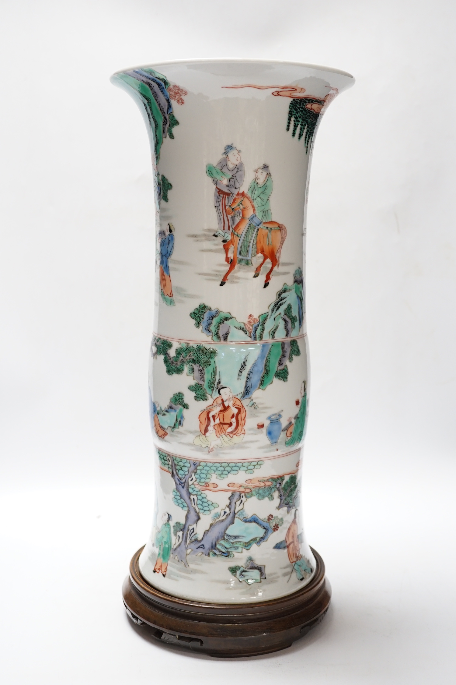 A Chinese famille verte beaker vase, Kangxi mark but later, on hardwood stand, 46cm total height